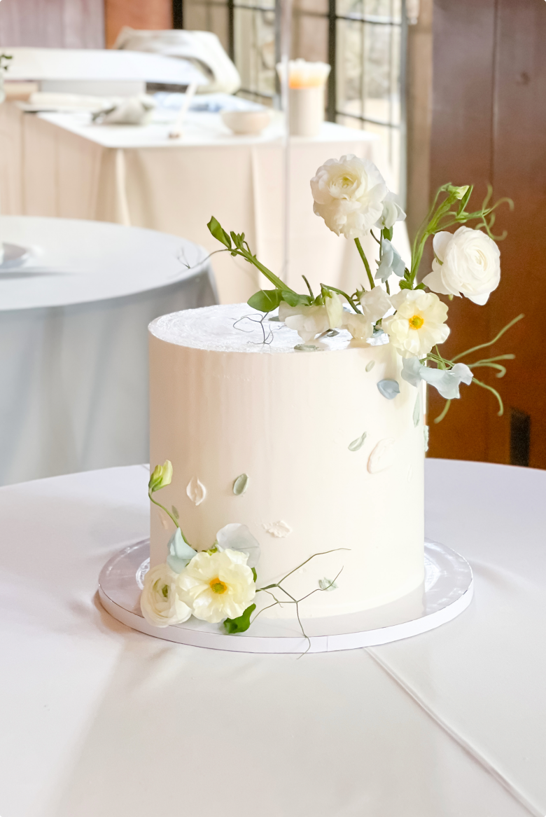 A white cake decorated with flowers